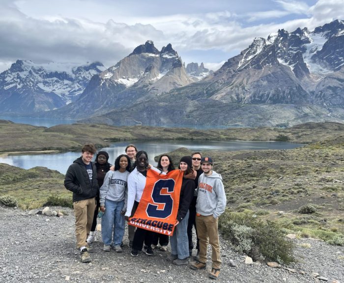 Students in Patagonia with SU flag