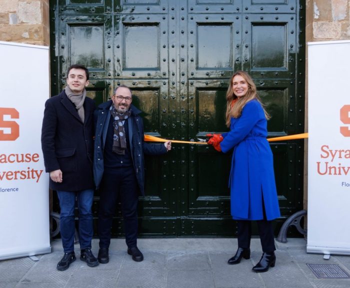 Three people standing at the doors of Syracuse Florence
